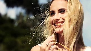 Petite blonde MILF beauty Cara Mell posing nude on the beach