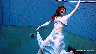 The redhead Marketa in a white dress in the pool