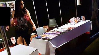 In a kitchen a sexy brunette playing with her big boobs