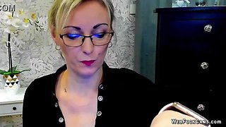 Blonde amateur German MILF LUXvanessa in mini skirt and black blouse with big cleavage flashing boobs on solo webcam show