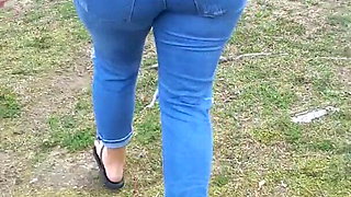 Woman wets jeans in park