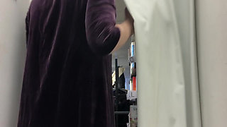 Getting naked to try a party dress and some trousers on in a charity shop