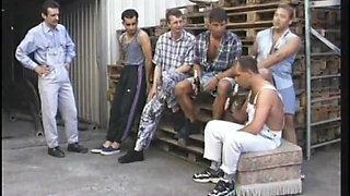 Dirty old blonde gets fucked from behind while sucking cock in gang bang