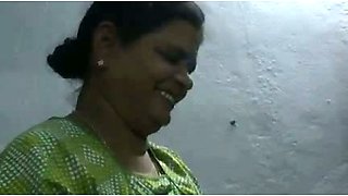 Mature and happy Indian aunty giving oily handjob on cam