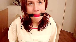 Gina ball gagged in a Posey straitjacket
