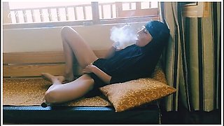 Arab milf’s risky window play with smoking allure