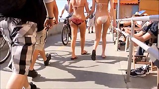Slender bikini babe with a wonderful ass enjoys the hot sun